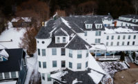 The 35,000-square-foot roof features 350 squares, 38 dormers, and two conical roof sections, one towering at six stories high.