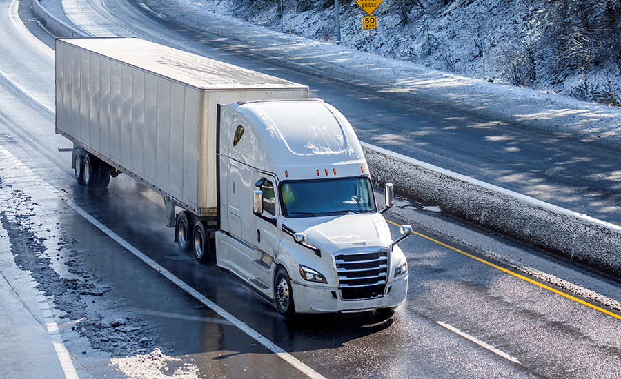 A picture of a long-haul truck driving down the road