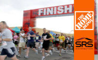 Pictured are runners at a marathon crossing the finish line, similar to Home Depot’s months-long plans to acquire SRS Distribution.