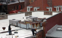 A construction crew paints a white roof in downtown Washington, D.C. (pictured).
