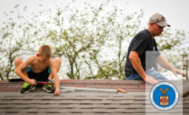 A man and a child on a roof (pictured). Image used under Creative Commons license. Photo by International Labor Organization.