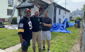 Ruben Gonzalez, pictured in the center, owner of AIS Construction.