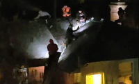 Roofers in the United Kingdom were placed at great safety risk after being seen working on a roof at night using cell phones for light.