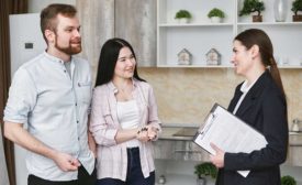 Two customers discussing roofing options with a sales representative