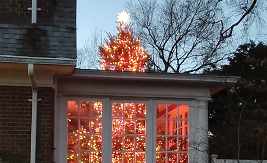 The illusion of a Christmas Tree busting through the roof of a home has gone viral.