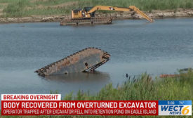 A screengrab showing the excavator overturned and the cab fully submerged following the accidental death of a 27-year-old construction worker in North Carolina. 