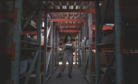 A woman standing in a warehouse